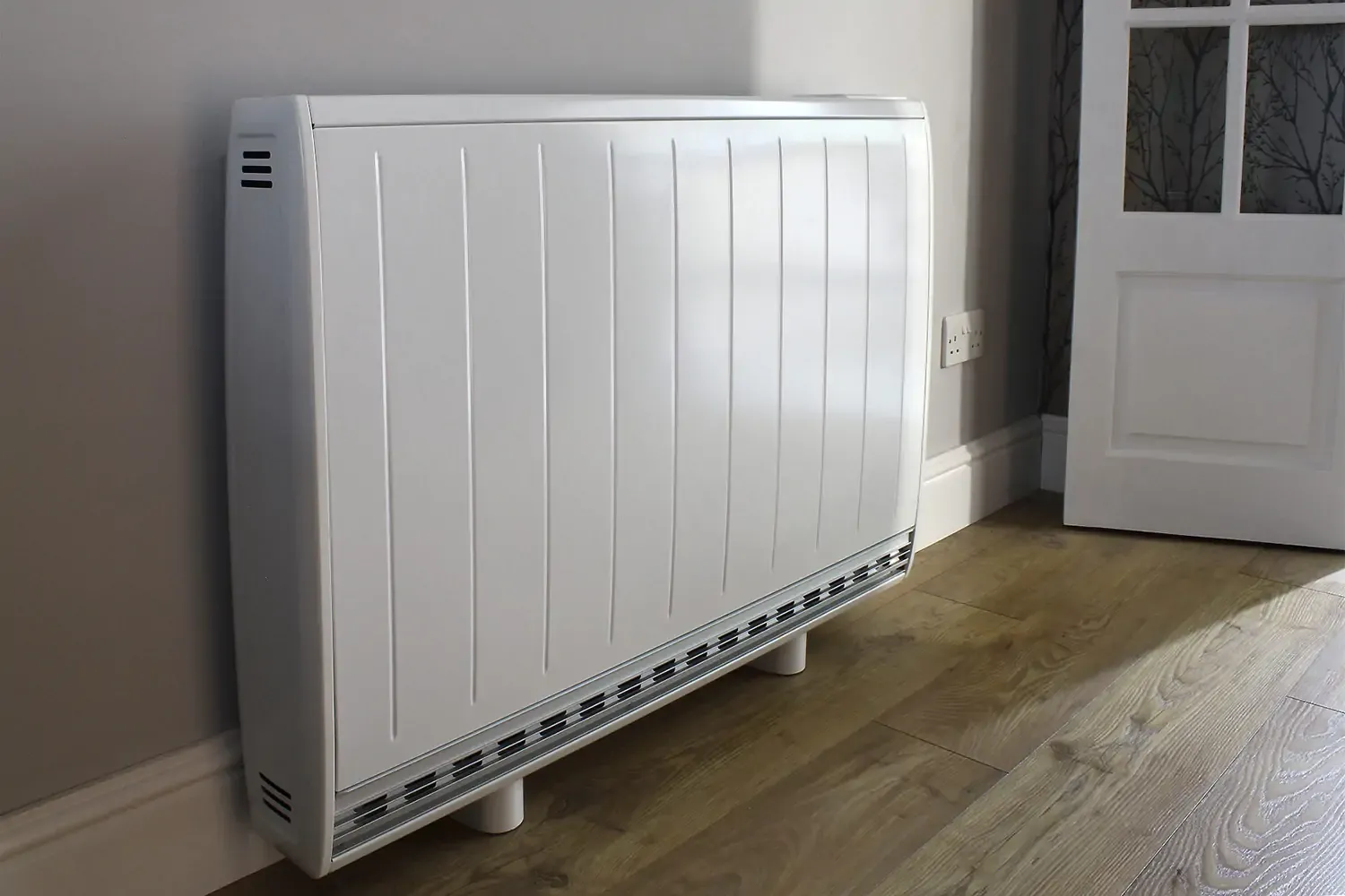 Electric storage heater mounted on wall, eligible for free electric storage heater grants through government funding