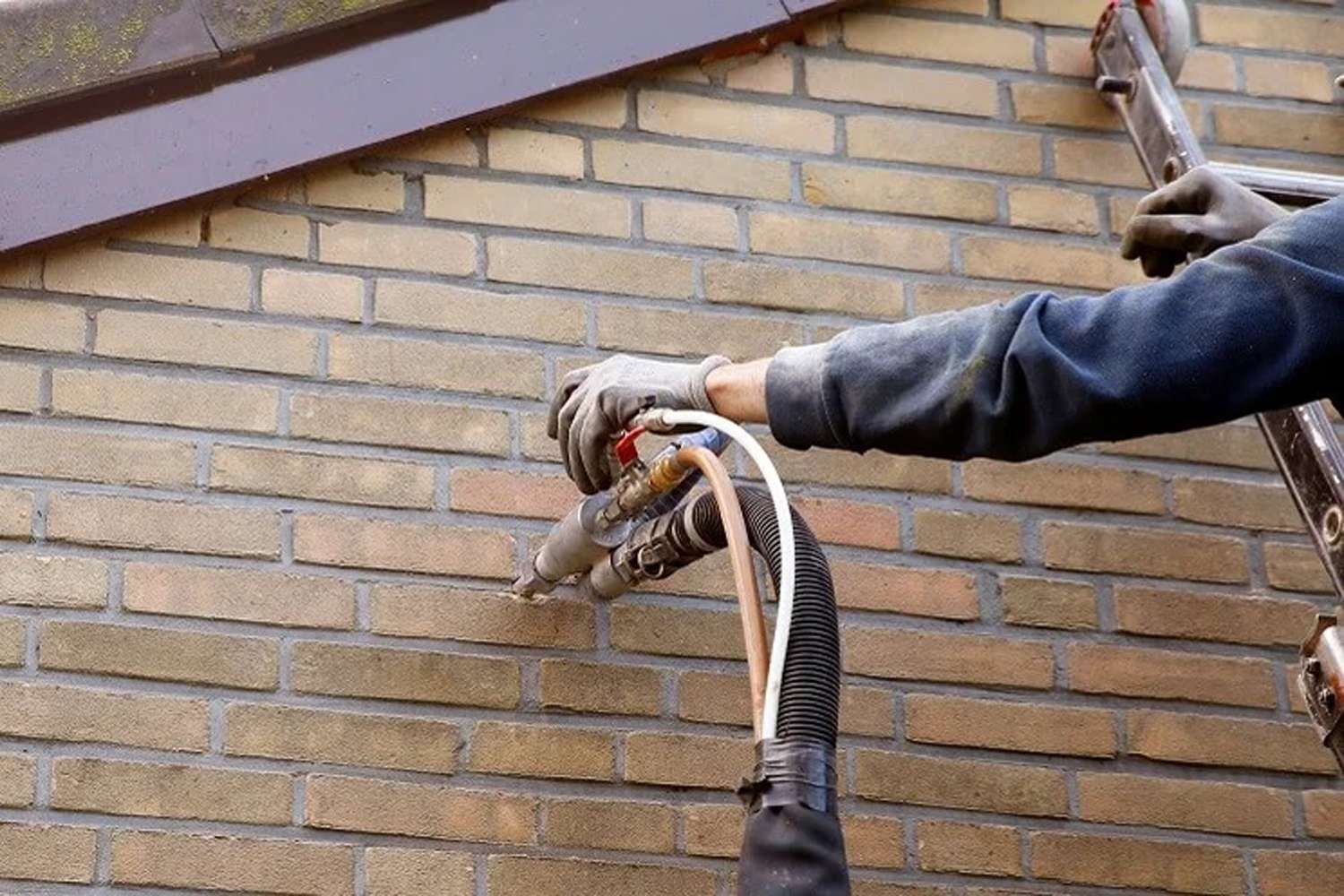 An engineer working on cavity wall insulation