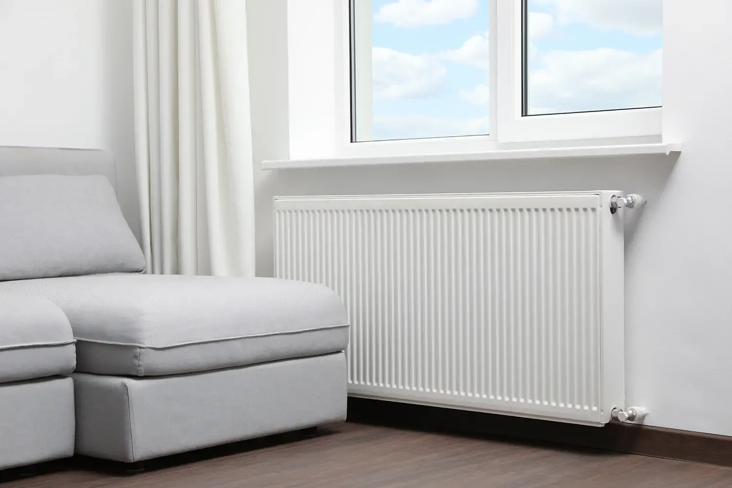 Radiator installed on wall as part of a first-time central heating grant installation in a UK home