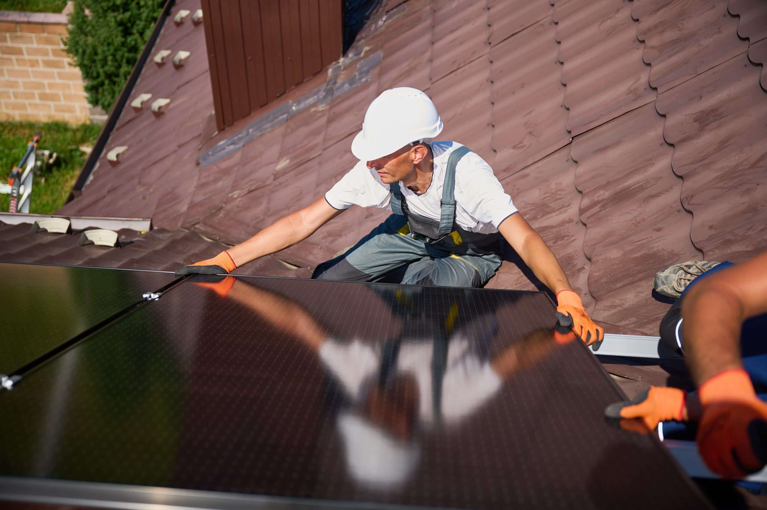 worker holding solar panel